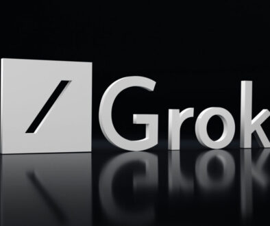 A 3D metallic logo with a slash in a square shape appears beside the word “Grok” in shiny silver letters. The logo and text are set against a glossy black background, with their reflections visible beneath them.